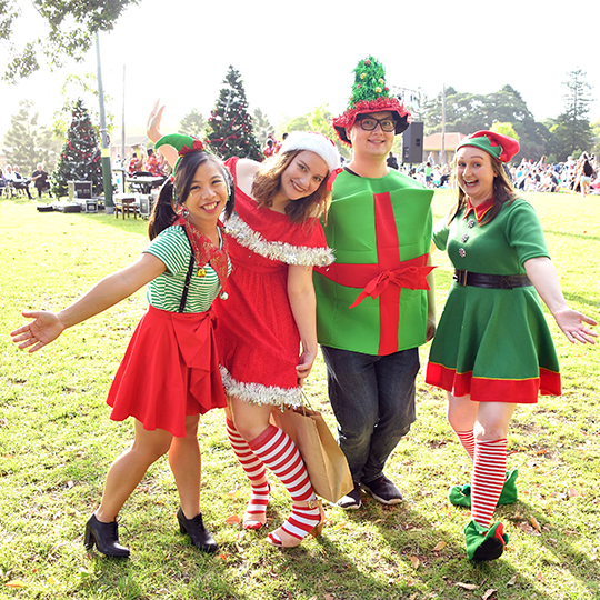 four people in christmas outfits